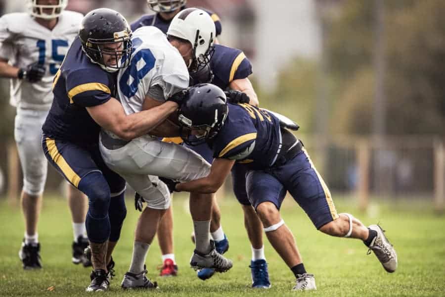 Football player being tackled on field