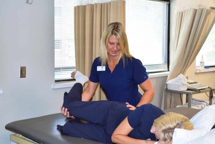 Physical therapist treating patient for hip impingement