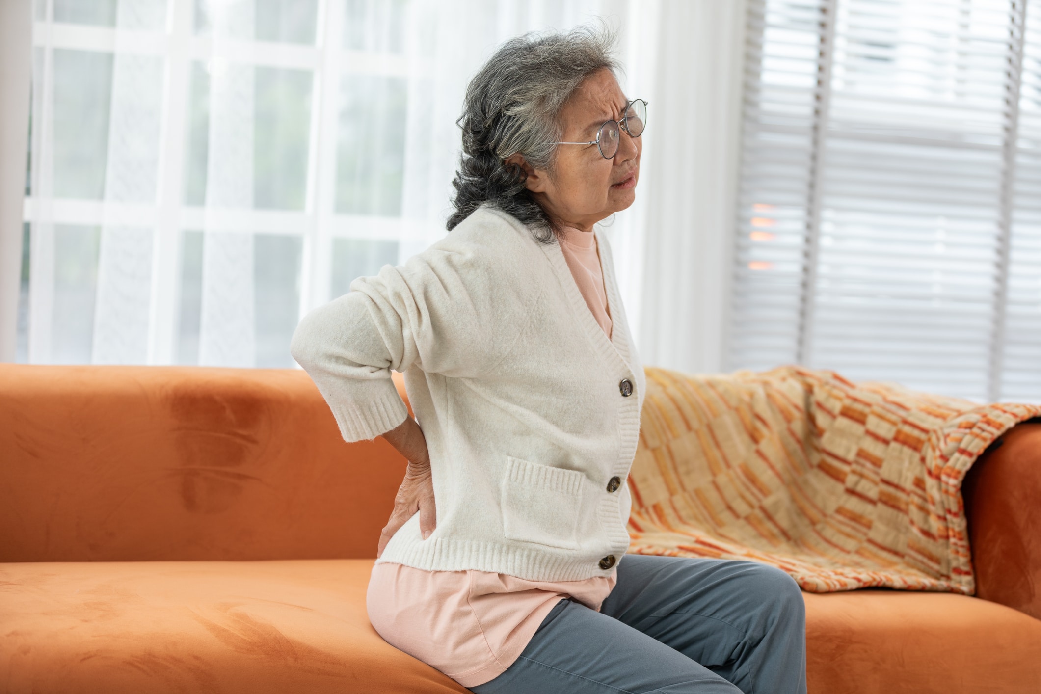 Senior patient holding back in pain