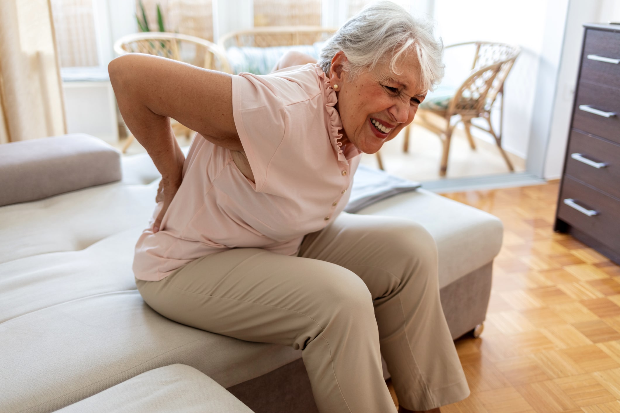 Senior patient holding back in pain