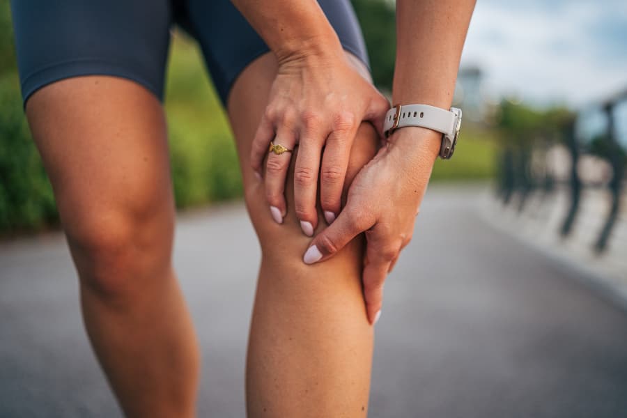 Athlete holding painful knee after training