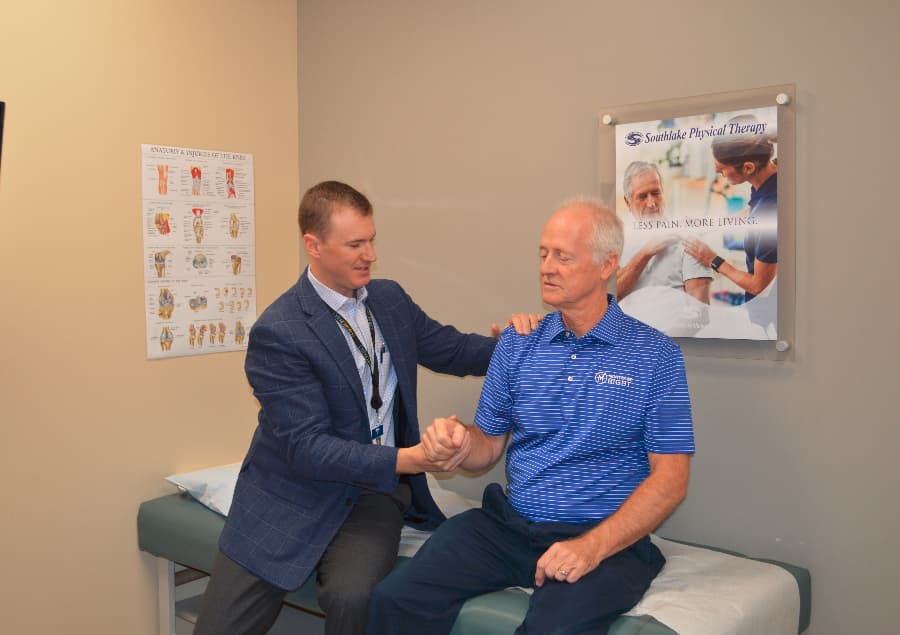 Dr. Jonathan Isbell examining patient for shoulder impingement