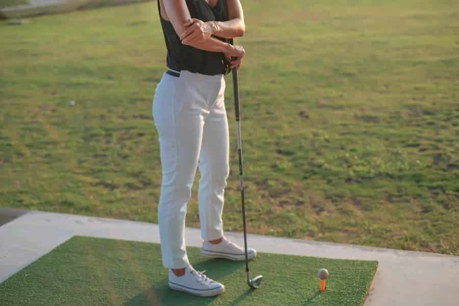 Golfer with golfer’s elbow holding painful elbow