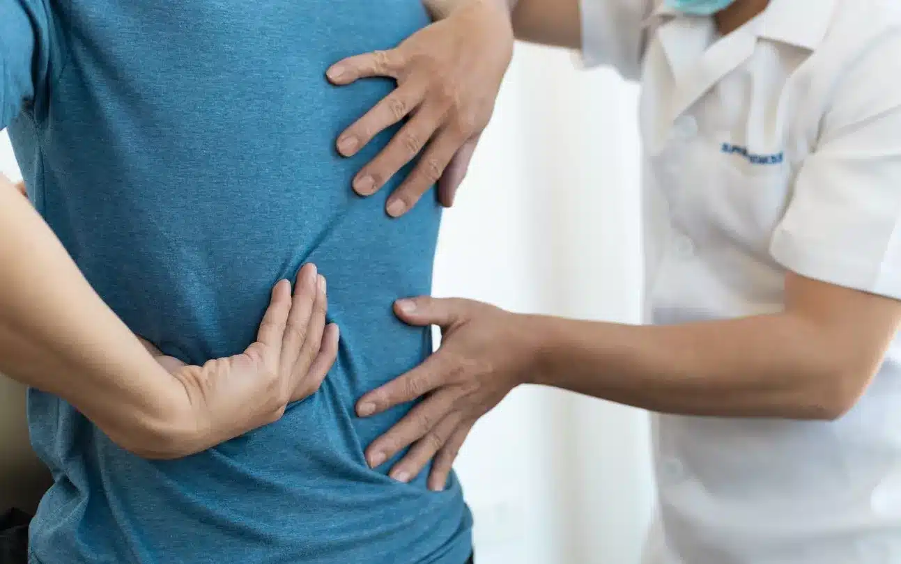 Physician consulting with patient on back pain
