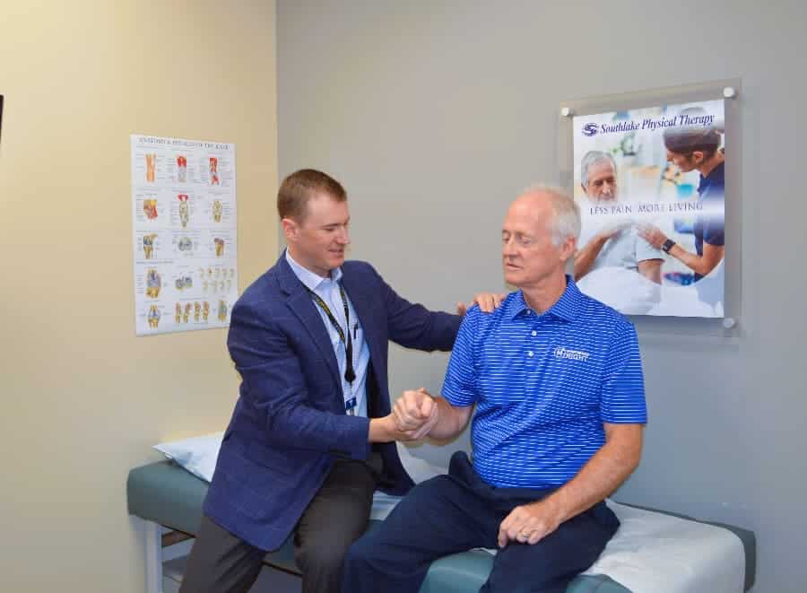 Dr. Jonathan Isbell examining patient shoulder