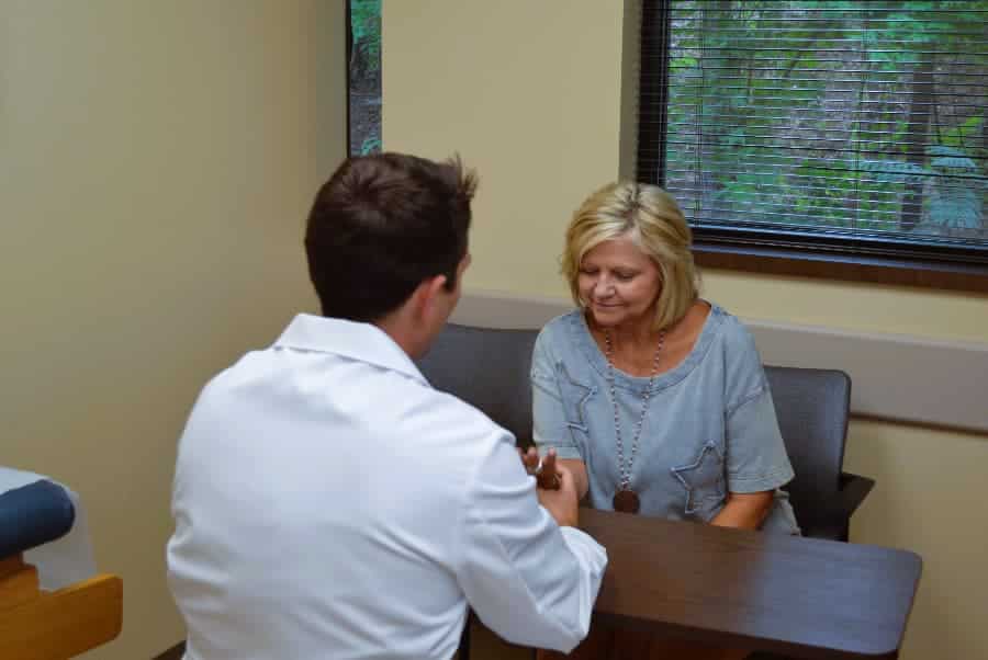Dr. Jonathon Whitehead examining patient elbow