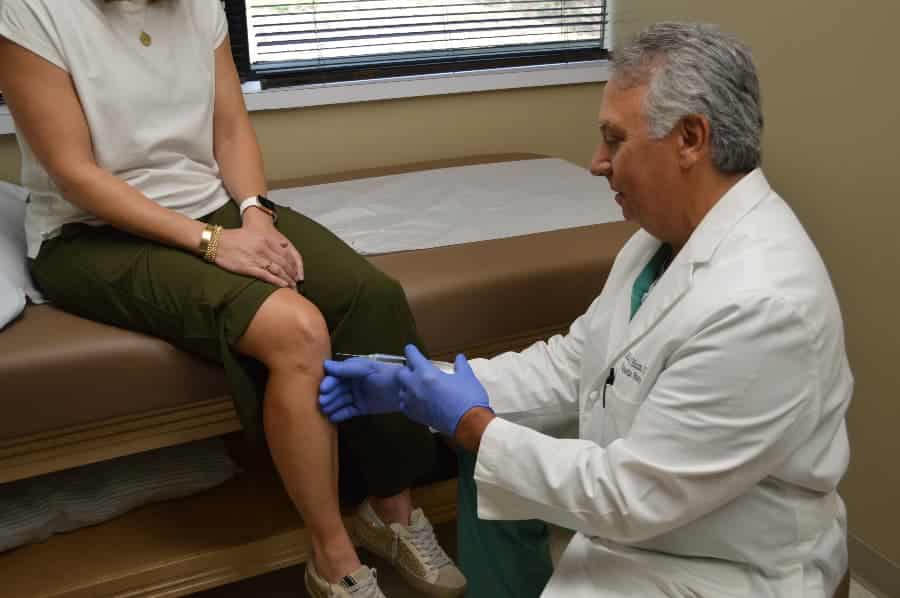 Dr. Michael Blum giving patient knee injection