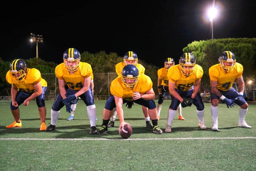 Youth football players on line of scrimmage
